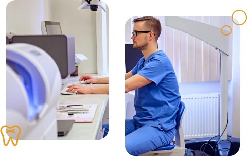 Side view of a healthcare man in blue scrubs typing on a computer